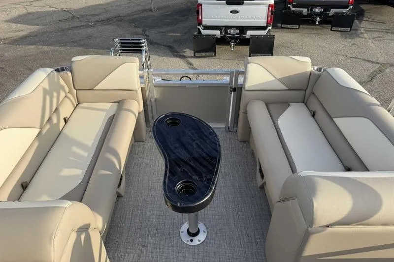 Slide: The Image of 2026 Avalon 2180 23 Venture QL pontoon boat interior with beige seating and black table. - 10