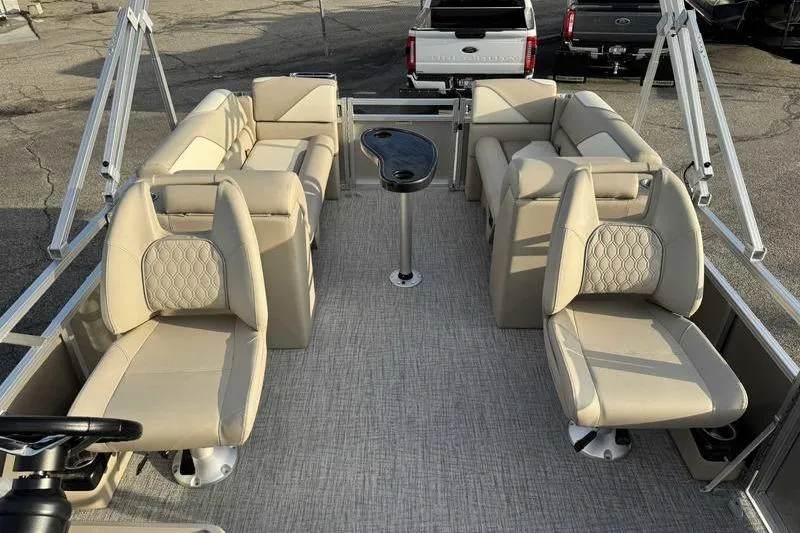 Slide: The Image of 2026 Avalon 2180 23 Venture QL pontoon boat interior with beige seating and central table. - 11