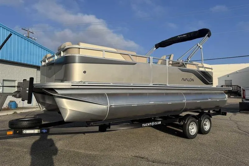 Slide: The Image of 2026 Avalon 2180 23 Venture QL pontoon boat on trailer, parked outdoors. - 5