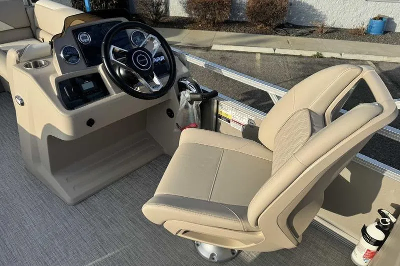 Slide: The Image of 2026 Avalon 2180 23 Venture QL boat interior with steering wheel and captain's chair. - 9
