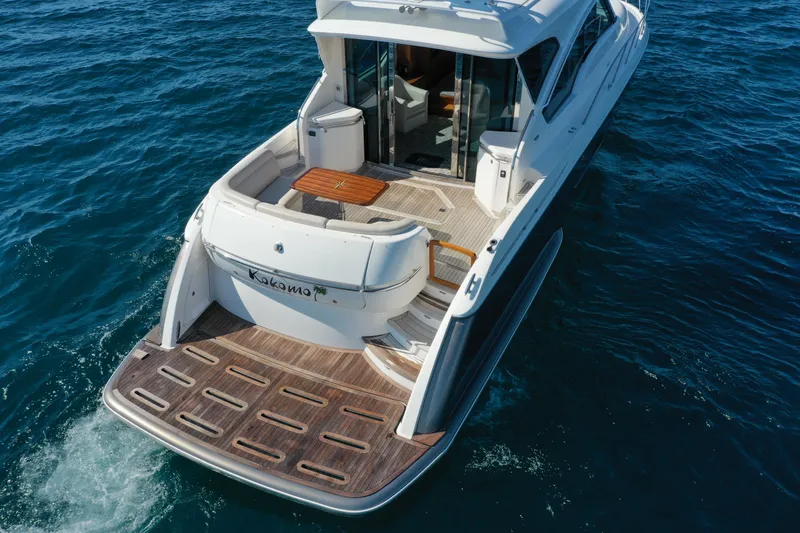 Slide: The Image of 2014 Tiara Yachts 5800 Sovran cruising on open water, showcasing elegant deck design. - 10