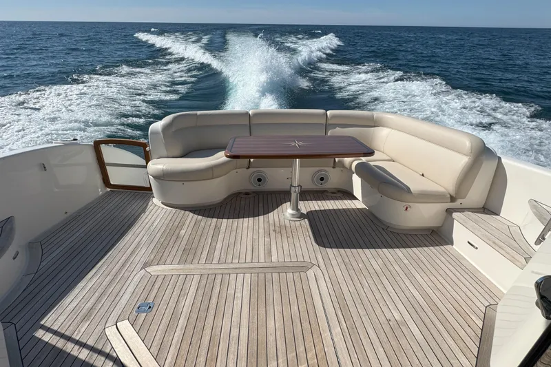 Slide: The Image of 2014 Tiara Yachts 5800 Sovran deck with seating, cruising on open water. - 11