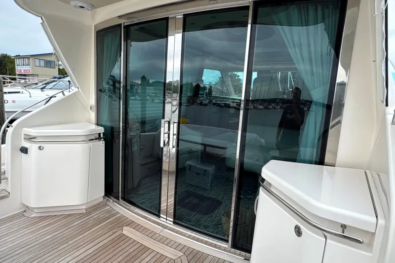 Slide: The Image of 2014 Tiara Yachts 5800 Sovran with sleek glass doors and modern deck design. - 13