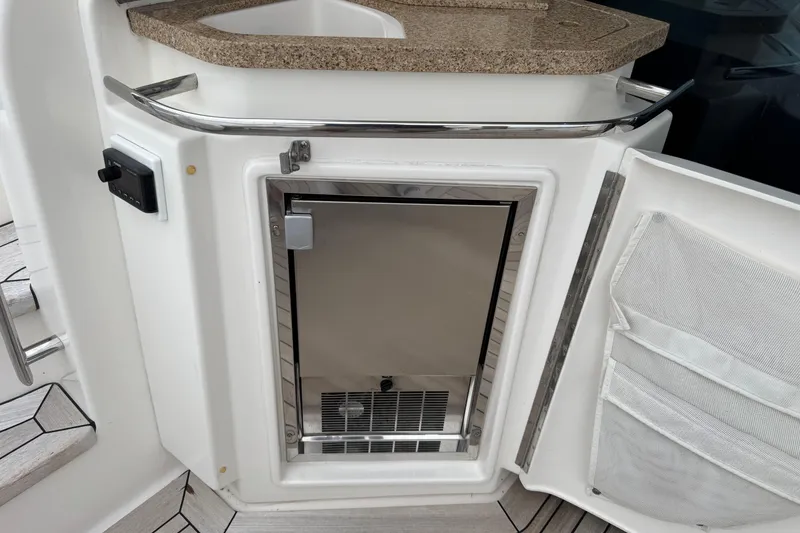 Slide: The Image of 2014 Tiara Yachts 5800 Sovran yacht kitchenette with mini fridge and countertop. - 14