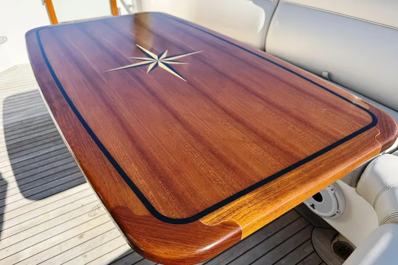 Slide: The Image of Luxurious wooden table with star design on 2014 Tiara Yachts 5800 Sovran. - 18