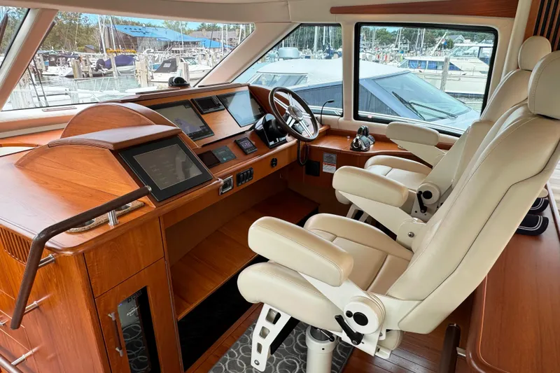 Slide: The Image of Luxurious helm of 2014 Tiara Yachts 5800 Sovran with modern navigation equipment. - 26