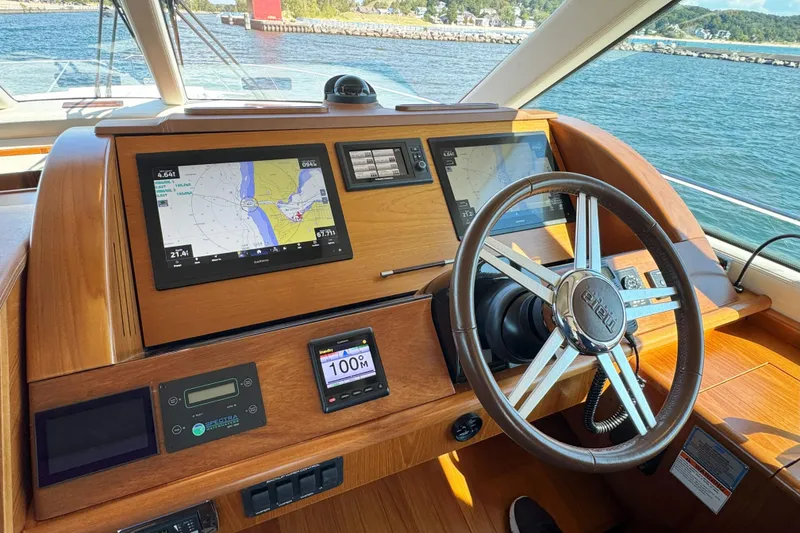Slide: The Image of Helm of 2014 Tiara Yachts 5800 Sovran with navigation screens and steering wheel. - 28