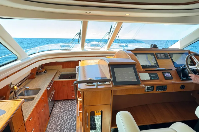 Slide: The Image of Interior of 2014 Tiara Yachts 5800 Sovran, featuring helm and kitchen area with ocean view. - 33