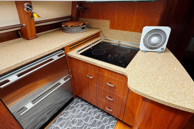 Slide: The Image of Luxurious 2014 Tiara Yachts 5800 Sovran kitchen with modern appliances and elegant wood cabinetry. - 35