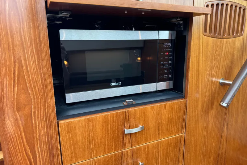 Slide: The Image of Built-in Galanz microwave in 2014 Tiara Yachts 5800 Sovran's wooden cabinet. - 36