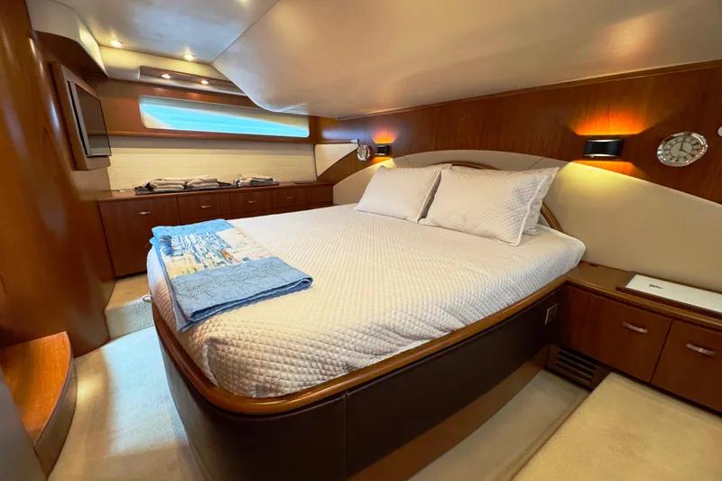 Slide: The Image of Luxurious bedroom interior of 2014 Tiara Yachts 5800 Sovran with elegant wood finishes. - 39