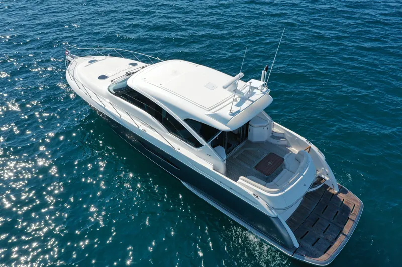 Slide: The Image of 2014 Tiara Yachts 5800 Sovran cruising on sparkling blue ocean waters. - 4