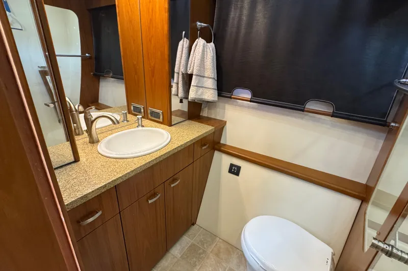 Slide: The Image of Luxurious bathroom in 2014 Tiara Yachts 5800 Sovran with elegant wood cabinetry. - 41