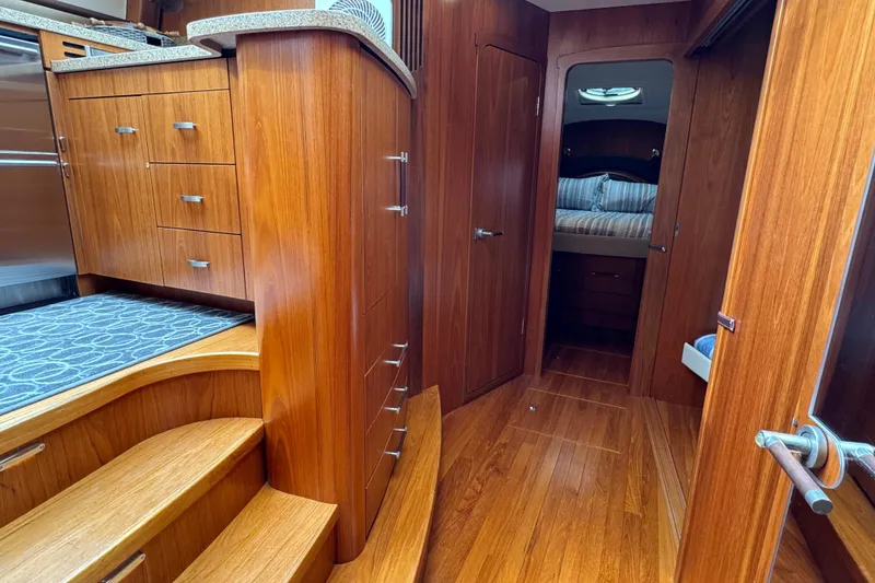Slide: The Image of Luxurious 2014 Tiara Yachts 5800 Sovran interior with wooden cabinetry and cozy bedroom. - 43