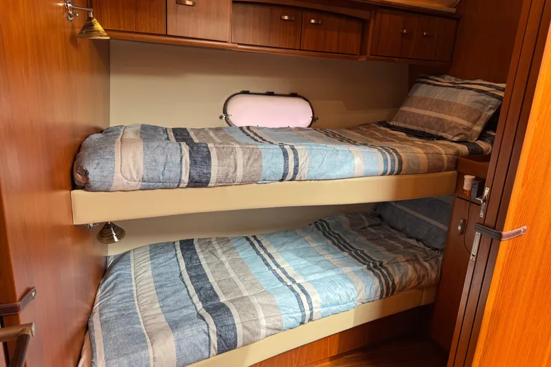 Slide: The Image of Bunk beds in 2014 Tiara Yachts 5800 Sovran cabin with striped bedding. - 46