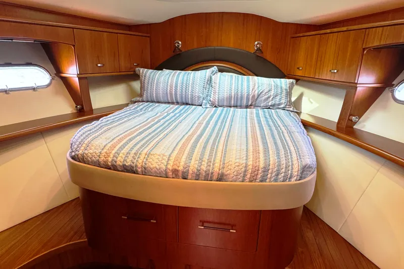 Slide: The Image of Luxurious cabin interior of 2014 Tiara Yachts 5800 Sovran with cozy bed and wooden cabinetry. - 47