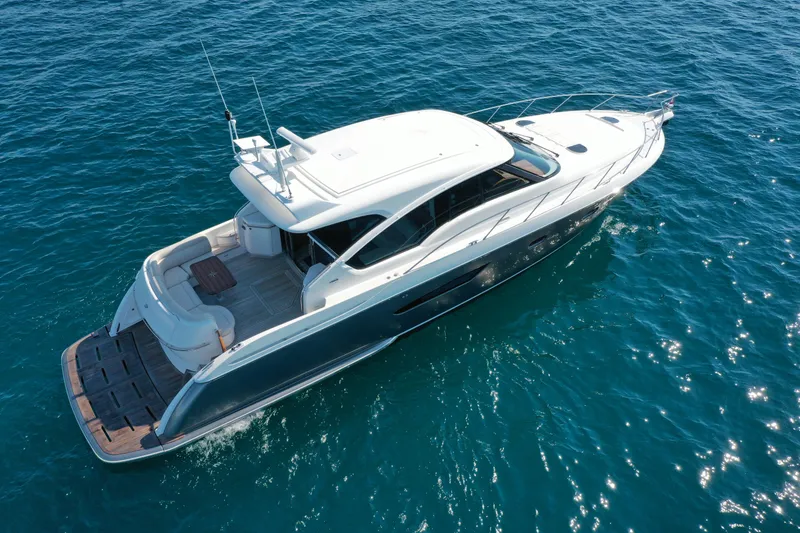 Slide: The Image of 2014 Tiara Yachts 5800 Sovran cruising on clear blue water. - 5