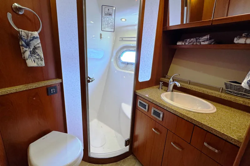 Slide: The Image of Luxurious bathroom in 2014 Tiara Yachts 5800 Sovran with shower, sink, and toilet. - 50