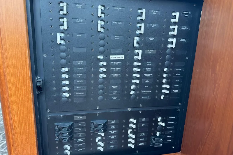 Slide: The Image of Electrical panel of a 2014 Tiara Yachts 5800 Sovran, featuring labeled switches and controls. - 52