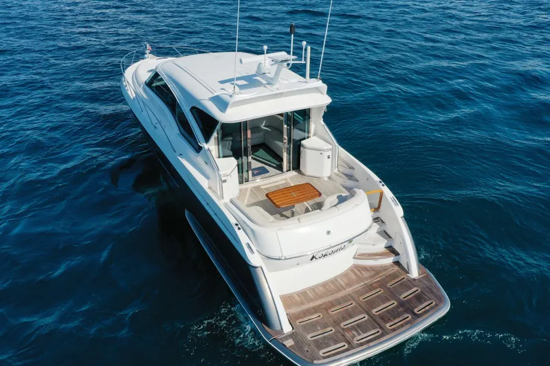 Slide: The Image of 2014 Tiara Yachts 5800 Sovran cruising on open water, rear view. - 6