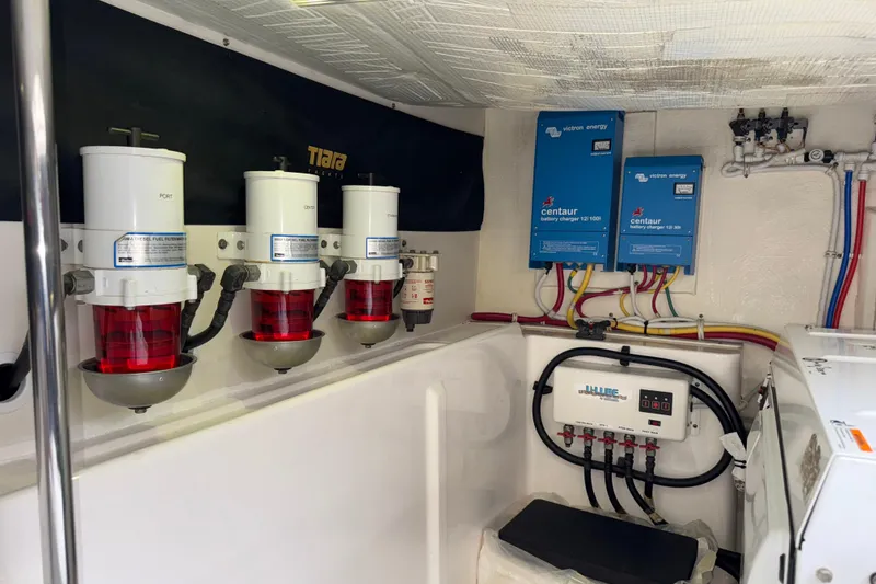 Slide: The Image of Engine room of 2014 Tiara Yachts 5800 Sovran with fuel filters and battery chargers. - 63