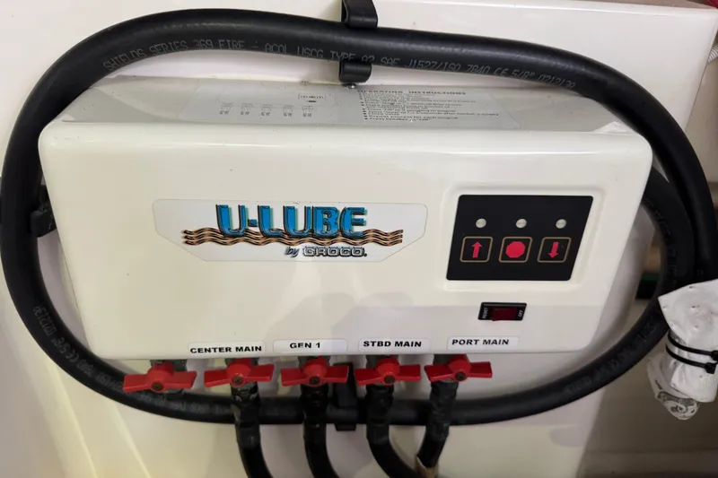 Slide: The Image of U-Lube system on 2014 Tiara Yachts 5800 Sovran, featuring control panel and labeled valves. - 68