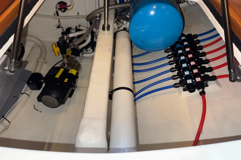 Slide: The Image of Engine room of 2014 Tiara Yachts 5800 Sovran with plumbing and mechanical components. - 69