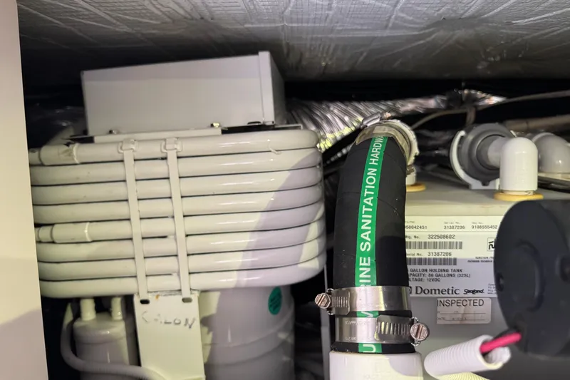 Slide: The Image of Engine room of 2014 Tiara Yachts 5800 Sovran, featuring marine sanitation hardware. - 70