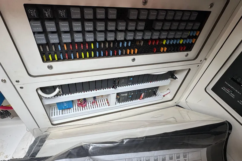 Slide: The Image of Electrical panel of a 2014 Tiara Yachts 5800 Sovran, showcasing circuit breakers and wiring. - 72