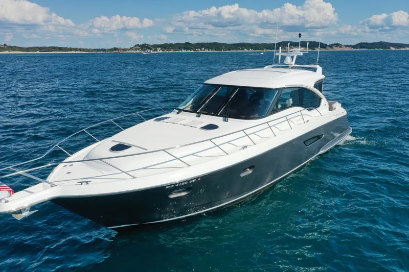 Slide: The Image of 2014 Tiara Yachts 5800 Sovran cruising on open water under a clear sky. - 8