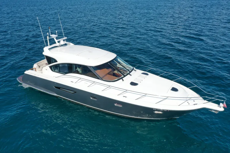 Slide: The Image of 2014 Tiara Yachts 5800 Sovran cruising on open blue water. - 9