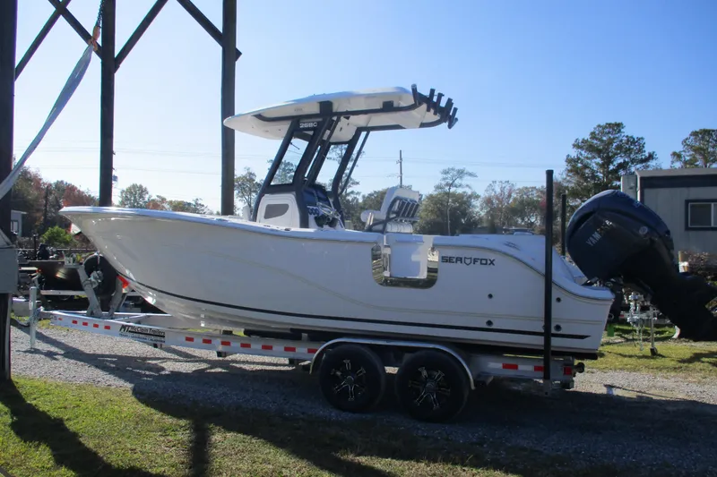 The Image of 2026 Sea Fox 268 Commander boat on trailer, parked outdoors. - 0