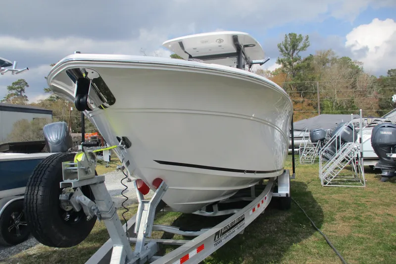 Slide: The Image of 2026 Sea Fox 268 Commander boat on trailer, displayed outdoors under cloudy sky. - 2