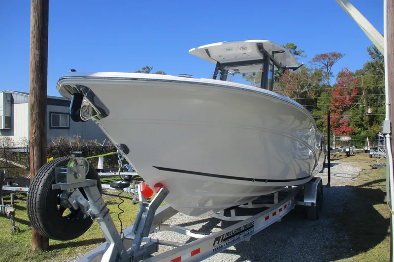 Slide: The Image of 2026 Sea Fox 268 Commander boat on trailer, parked outdoors under clear blue sky. - 3