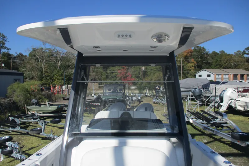 Slide: The Image of 2026 Sea Fox 268 Commander boat, view of helm and T-top, parked outdoors. - 8