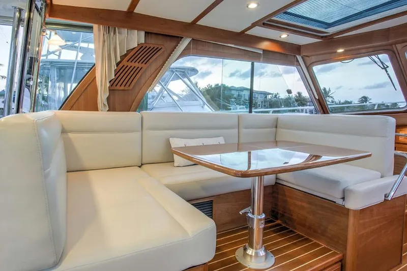 Slide: The Image of Luxurious interior of 2026 Sabre 38 yacht with elegant seating and wooden table. - 3