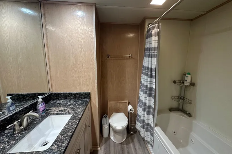 Slide: The Image of Bathroom in 1999 Sumerset 18x94 houseboat with granite countertop and shower. - 11