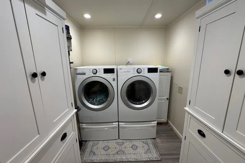 Slide: The Image of Laundry room with white cabinets and modern washer-dryer set, Sumerset 18x94, 1999 model. - 12