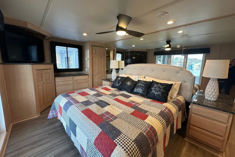 Slide: The Image of Luxurious bedroom in 1999 Sumerset 18x94 houseboat with quilted bedspread and nautical decor. - 13