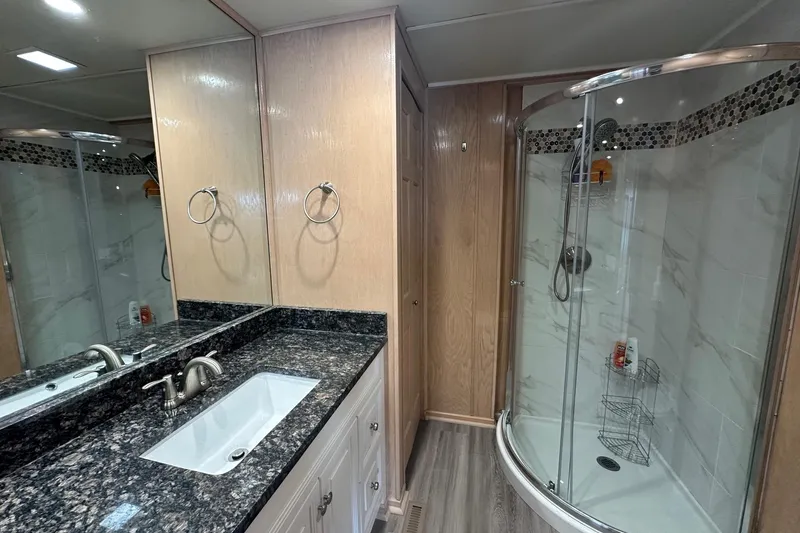 Slide: The Image of Luxurious bathroom in 1999 Sumerset 18x94 houseboat with modern shower and granite countertop. - 14