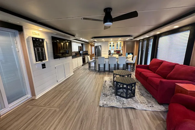 Slide: The Image of Luxurious 1999 Sumerset 18x94 houseboat interior with modern kitchen, red sofa, and stylish decor. - 2