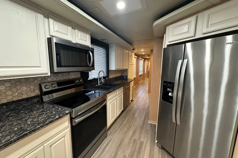Slide: The Image of Modern kitchen in a 1999 Sumerset 18x94 houseboat with stainless steel appliances. - 4