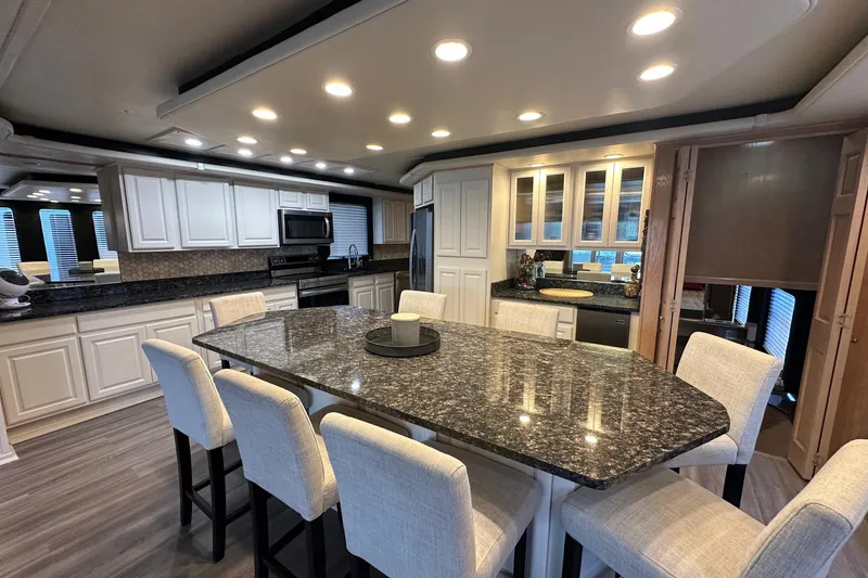 Slide: The Image of Luxurious kitchen interior of 1999 Sumerset 18x94 houseboat with granite countertops and modern lighting. - 5
