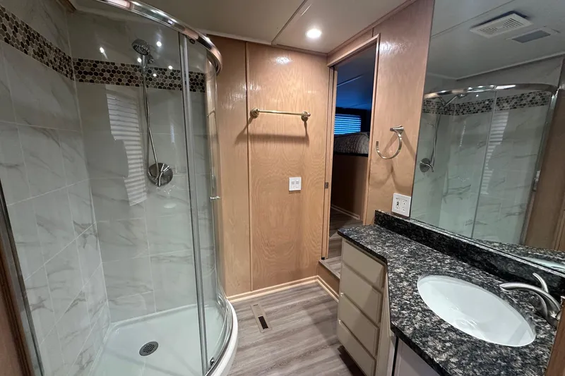 Slide: The Image of Luxurious bathroom in 1999 Sumerset 18x94 houseboat with modern shower and granite countertop. - 9