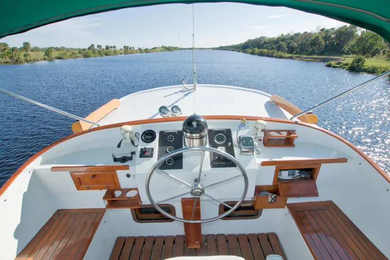 Slide: The Image of Helm of 1980 Kadey-Krogen 42 trawler on a scenic river. - 13