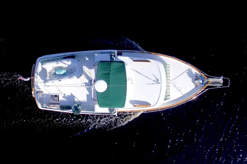 Slide: The Image of Overhead view of 1980 Kadey-Krogen 42 trawler cruising on dark water. - 2
