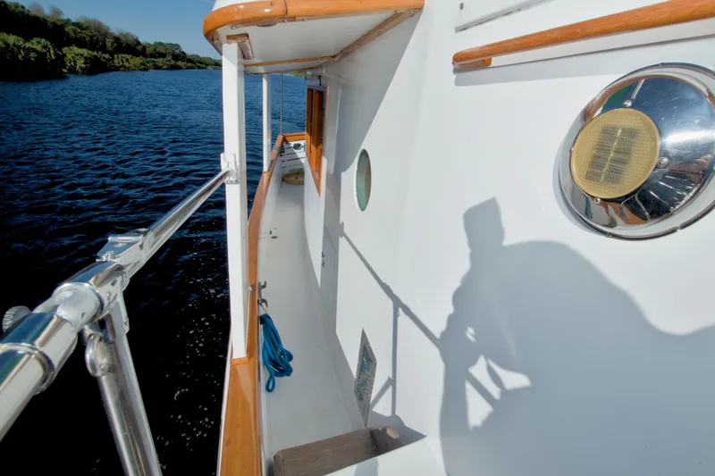 Slide: The Image of 1980 Kadey-Krogen 42 trawler deck view with railing and water backdrop. - 28