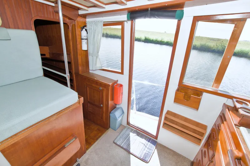 Slide: The Image of Interior of 1980 Kadey-Krogen 42 trawler with wood paneling and water view. - 35