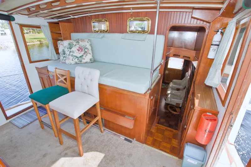 Slide: The Image of Interior of 1980 Kadey-Krogen 42 trawler with seating, wooden accents, and nautical decor. - 36