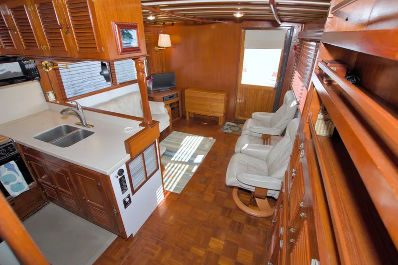 Slide: The Image of Interior of 1980 Kadey-Krogen 42 trawler with wood paneling and cozy seating area. - 37